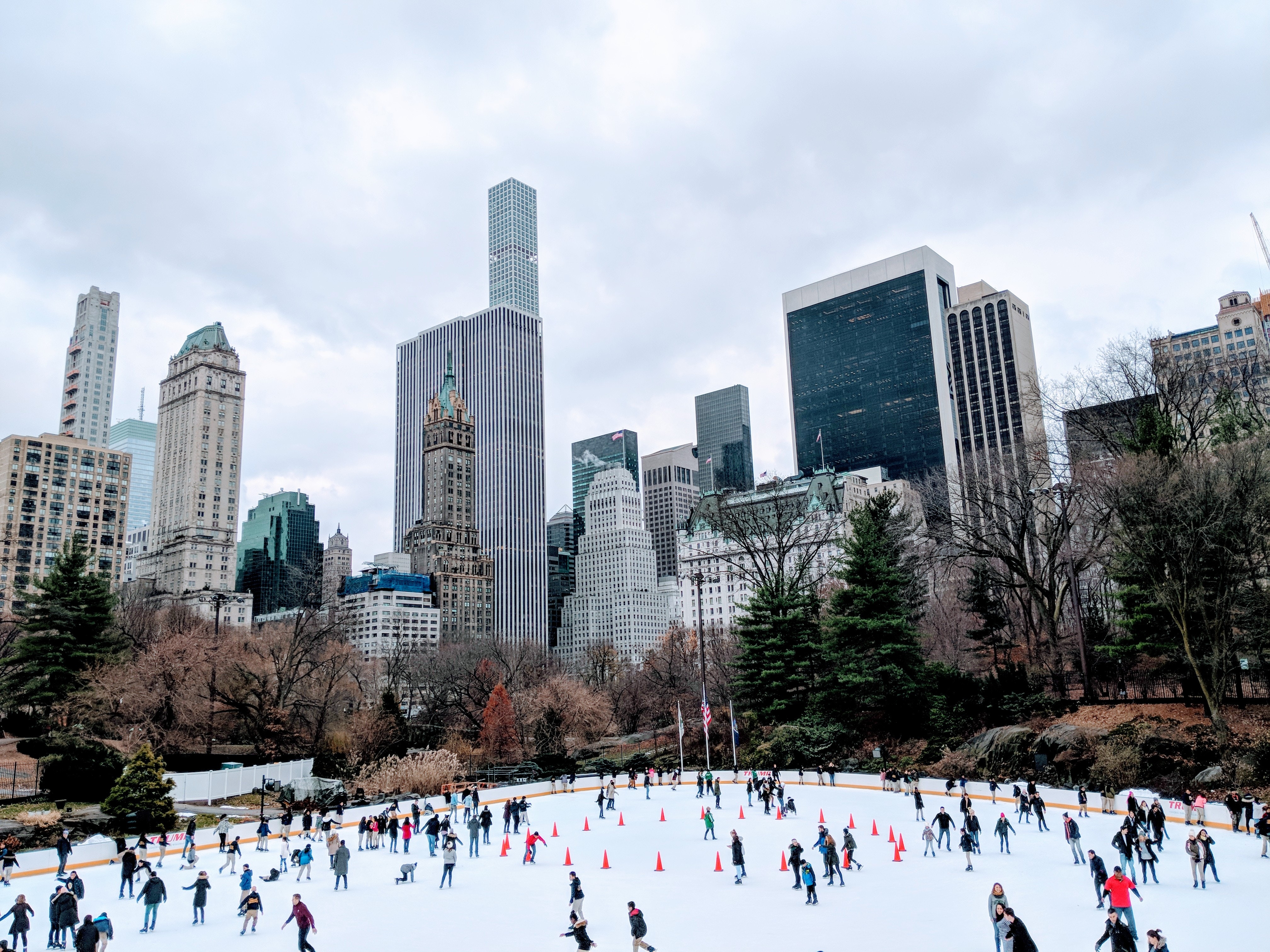 People skating on an ice rink in a big city